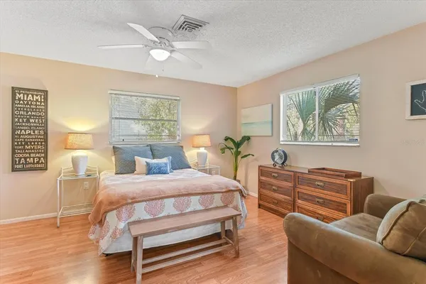 a bedroom with a bed a couch and dresser