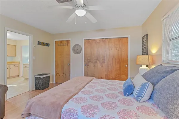 a bedroom with a large bed and chandelier