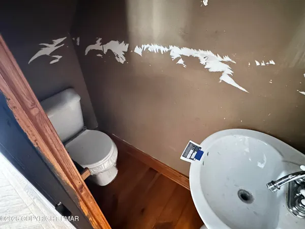 a bathroom with a toilet sink and mirror
