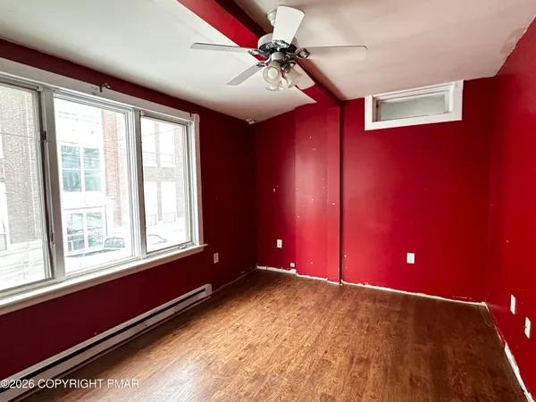 a view of a livingroom with a window and a ceiling fan