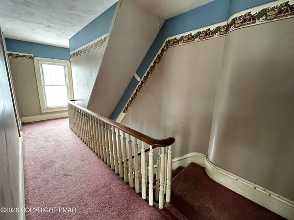 a view of a hallway with staircase