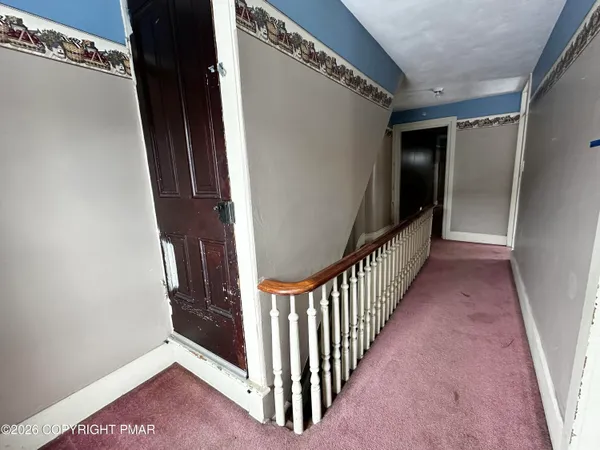 a view of a hallway with staircase