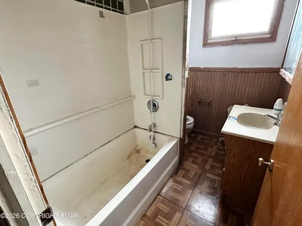 a bathroom with a sink a toilet and bathtub