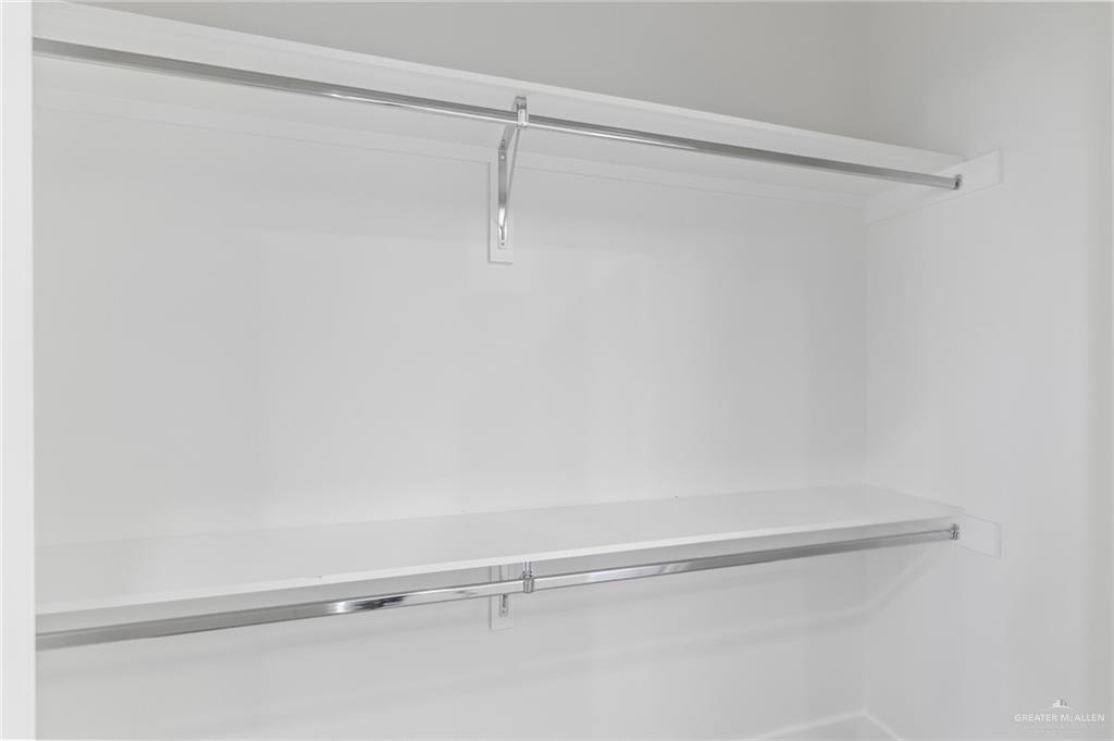 449 Padre Road Donna, TX 78537 - Photo 10 of 22 White closet featuring two shelves and two chrome hanging rods