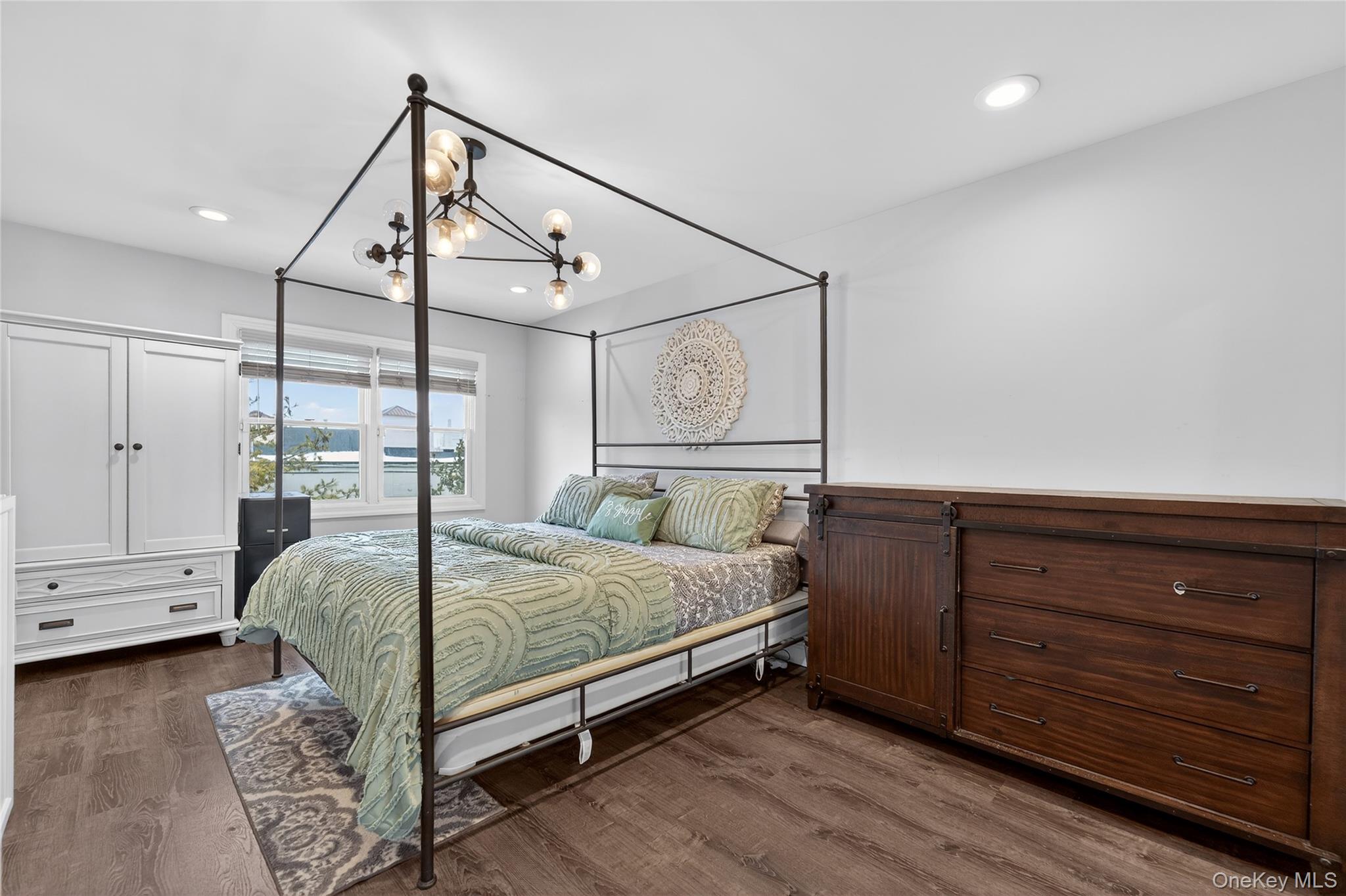 3530 Long Beach Road, Unit 8 Oceanside, NY 11572 - Photo 11 of 19 a bedroom with a bed and ceiling fan