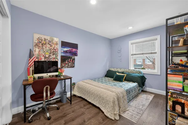 a bedroom with furniture and a book shelf