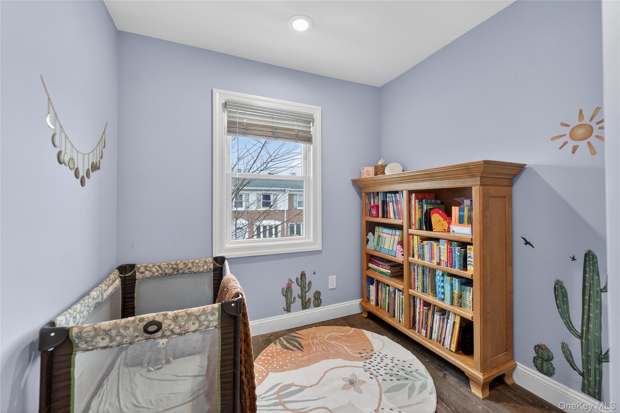 3530 Long Beach Road, Unit 8 Oceanside, NY 11572 - Photo 13 of 19 a bedroom with furniture and a book shelf