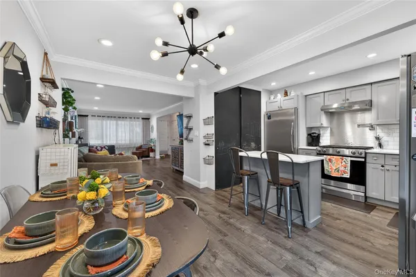 a very nice looking kitchen with furniture and wooden floor