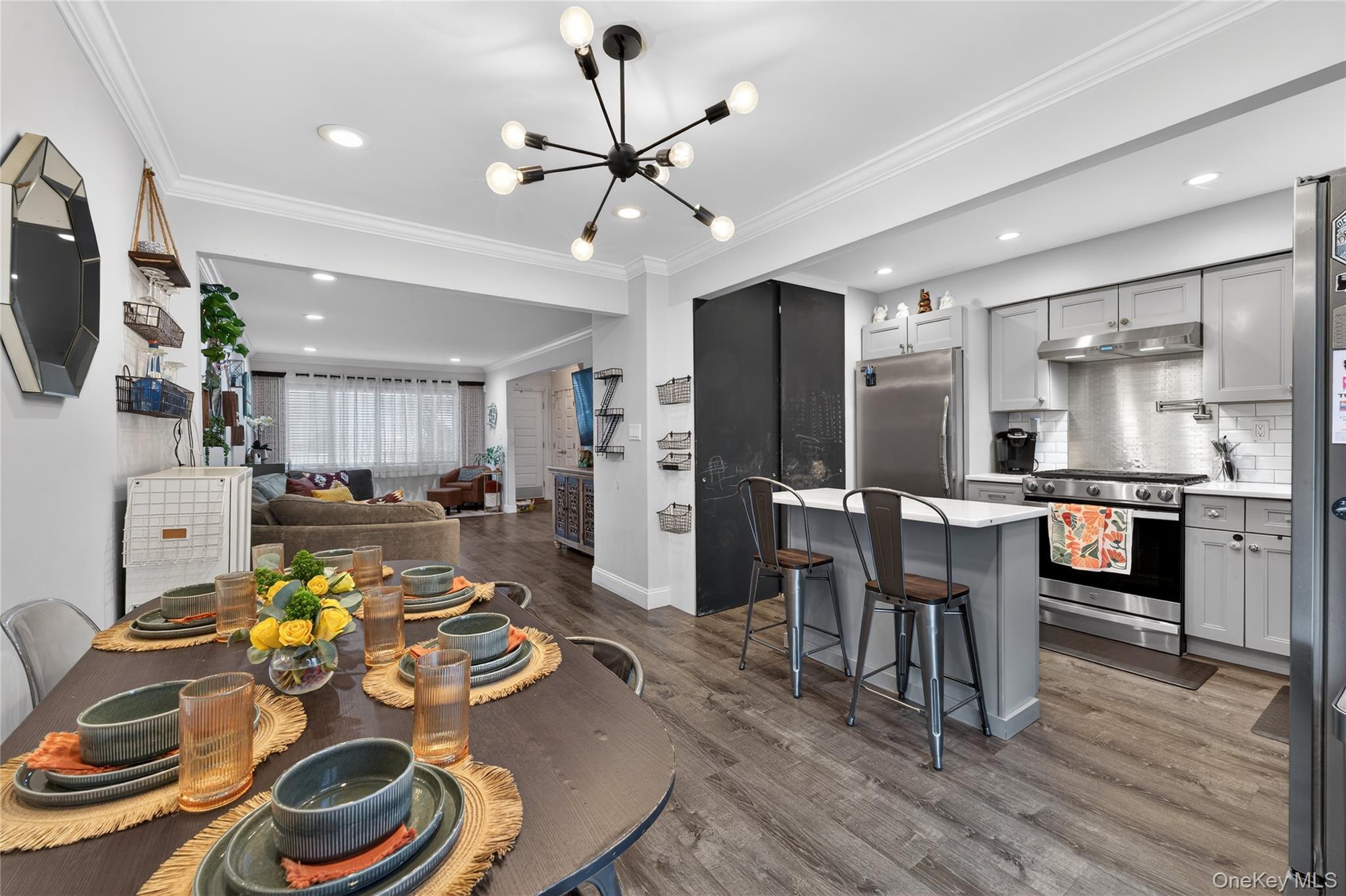 3530 Long Beach Road, Unit 8 Oceanside, NY 11572 - Photo 5 of 19 a very nice looking kitchen with furniture and wooden floor