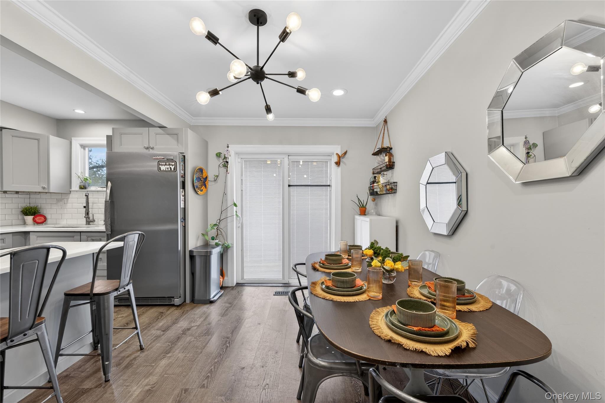 3530 Long Beach Road, Unit 8 Oceanside, NY 11572 - Photo 7 of 19 a kitchen with a dining table and chairs