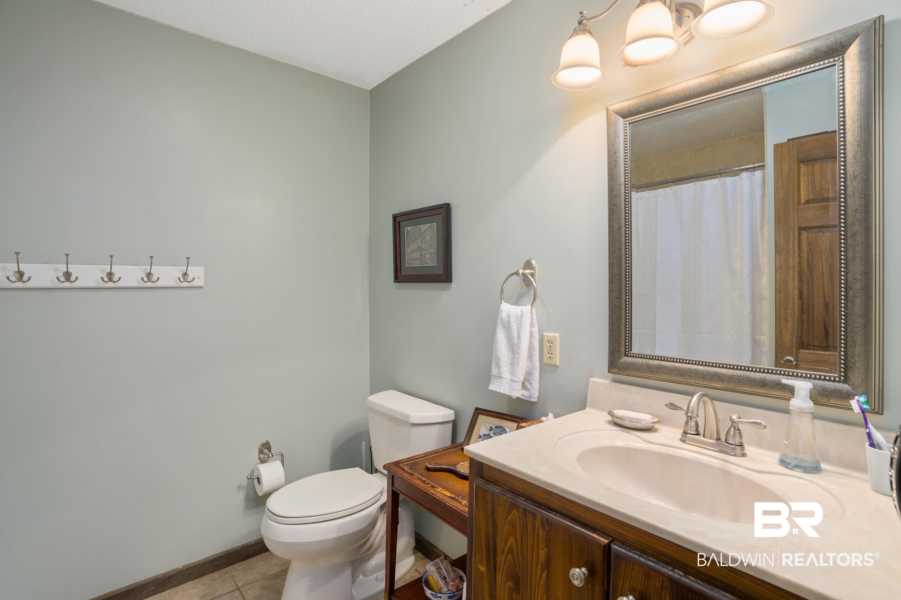 13253 Mary Ann Bch Road Fairhope, AL 36532 - Photo 23 of 54 Bathroom with tile floors, oversized vanity, and toilet