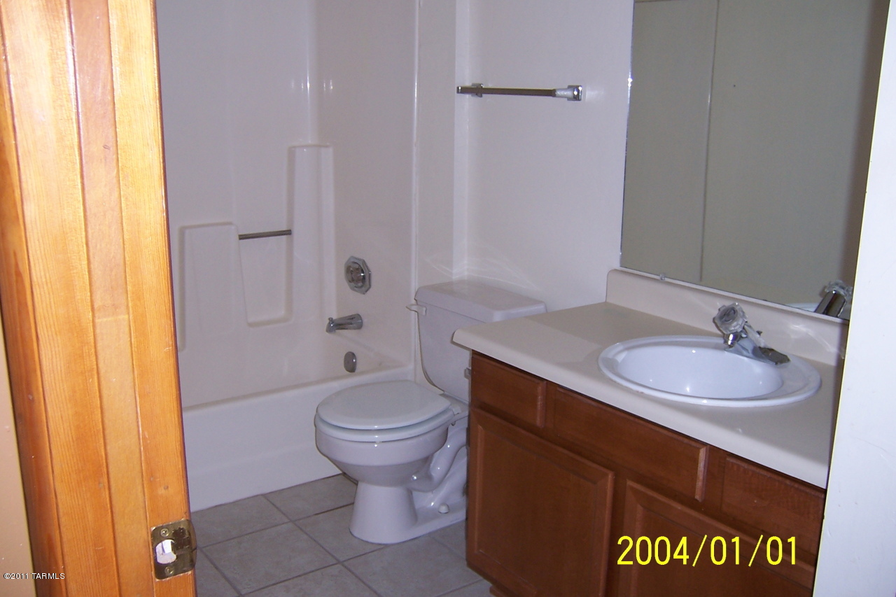 7777 East Golf Links Road, Unit 2205 Tucson, AZ 85730 - Photo 6 of 22 a bathroom with a sink toilet and shower