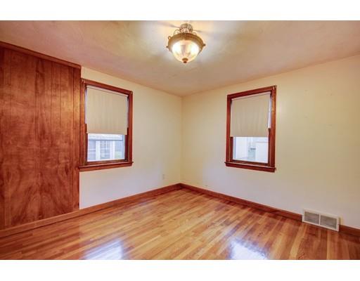 84 Campechi Street Springfield, MA 01104 - Photo 15 of 26 a view of an empty room with window and wooden floor