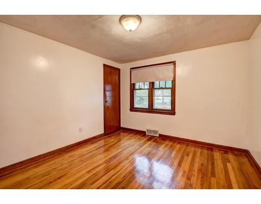 84 Campechi Street Springfield, MA 01104 - Photo 16 of 26 a view of an empty room with window and wooden floor