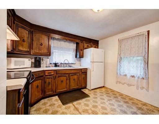84 Campechi Street Springfield, MA 01104 - Photo 7 of 26 a kitchen with stainless steel appliances granite countertop a refrigerator a stove and a sink with cabinets
