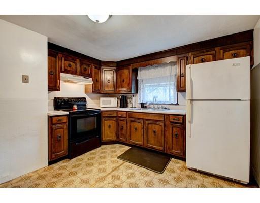 84 Campechi Street Springfield, MA 01104 - Photo 8 of 26 a kitchen with a refrigerator and a stove