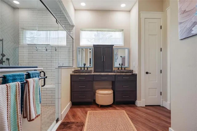 a spacious bathroom with a granite countertop sink a toilet and shower