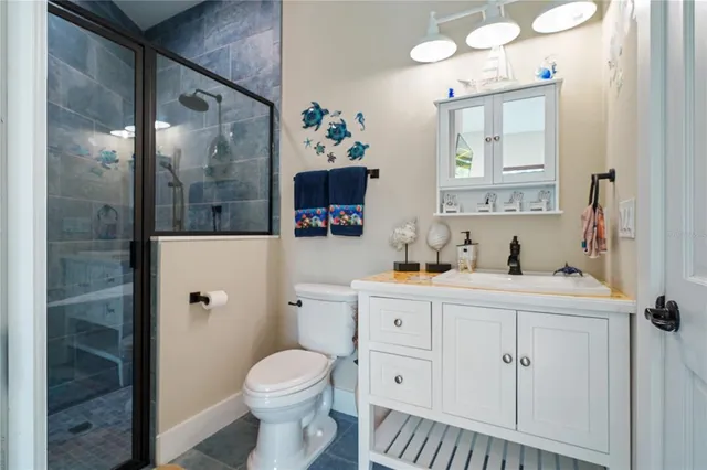 an aerial view of lake residential house with outdoor space and trees around