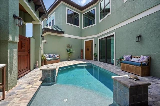 an aerial view of residential houses with outdoor space and trees