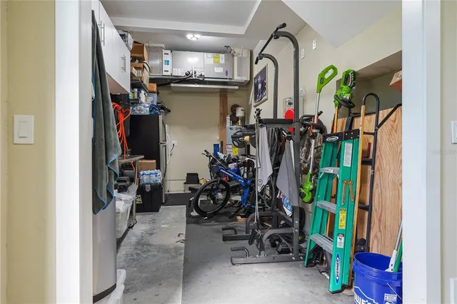 an aerial view of a house with a yard and lake view
