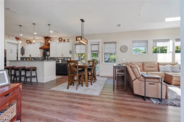 a very nice looking living room with wooden floor furniture and a chandelier