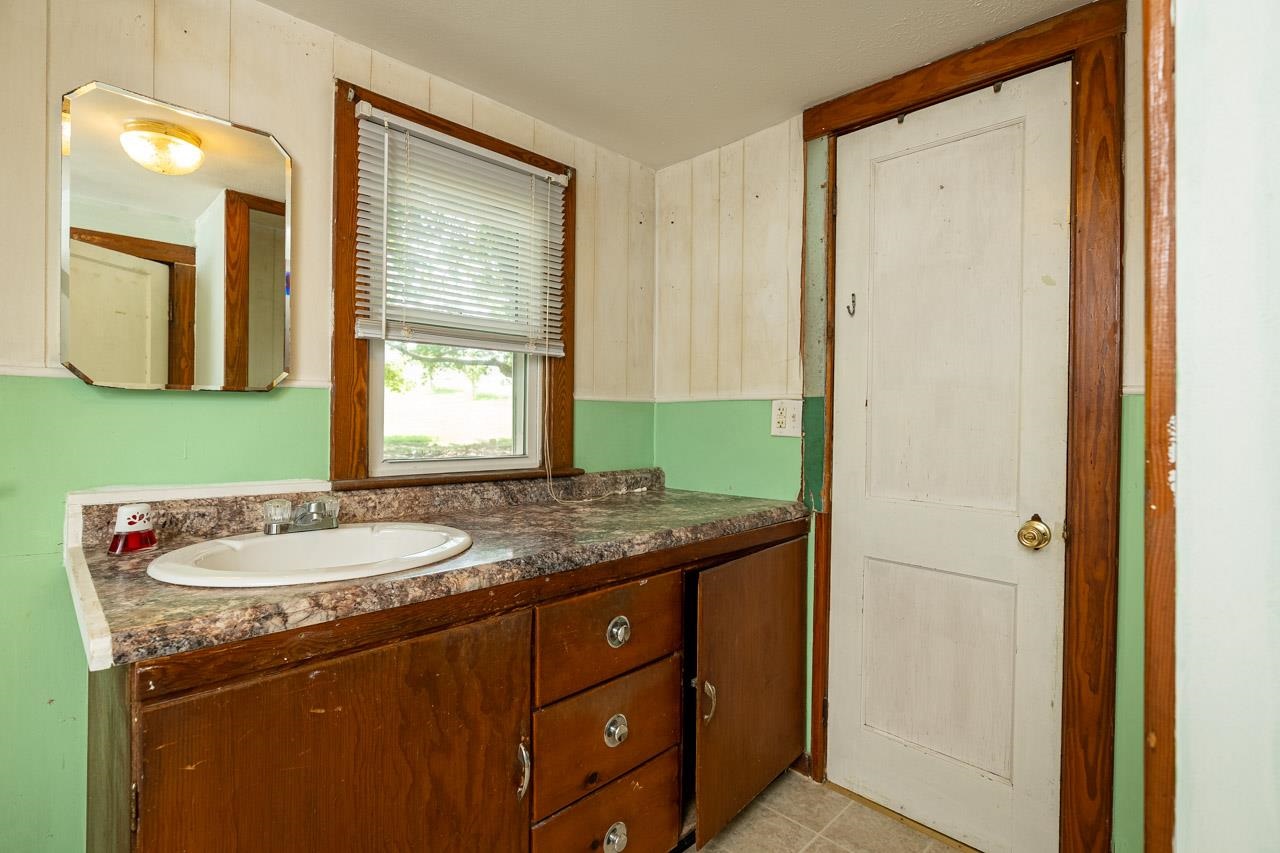 3697 Oak Ridge Road Mount Crawford, VA 22841 - Photo 13 of 34 a bathroom with a granite countertop sink and a mirror