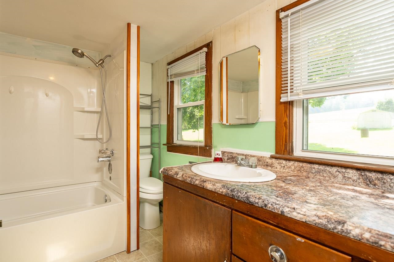 3697 Oak Ridge Road Mount Crawford, VA 22841 - Photo 18 of 34 a bathroom with a granite countertop sink and a large mirror