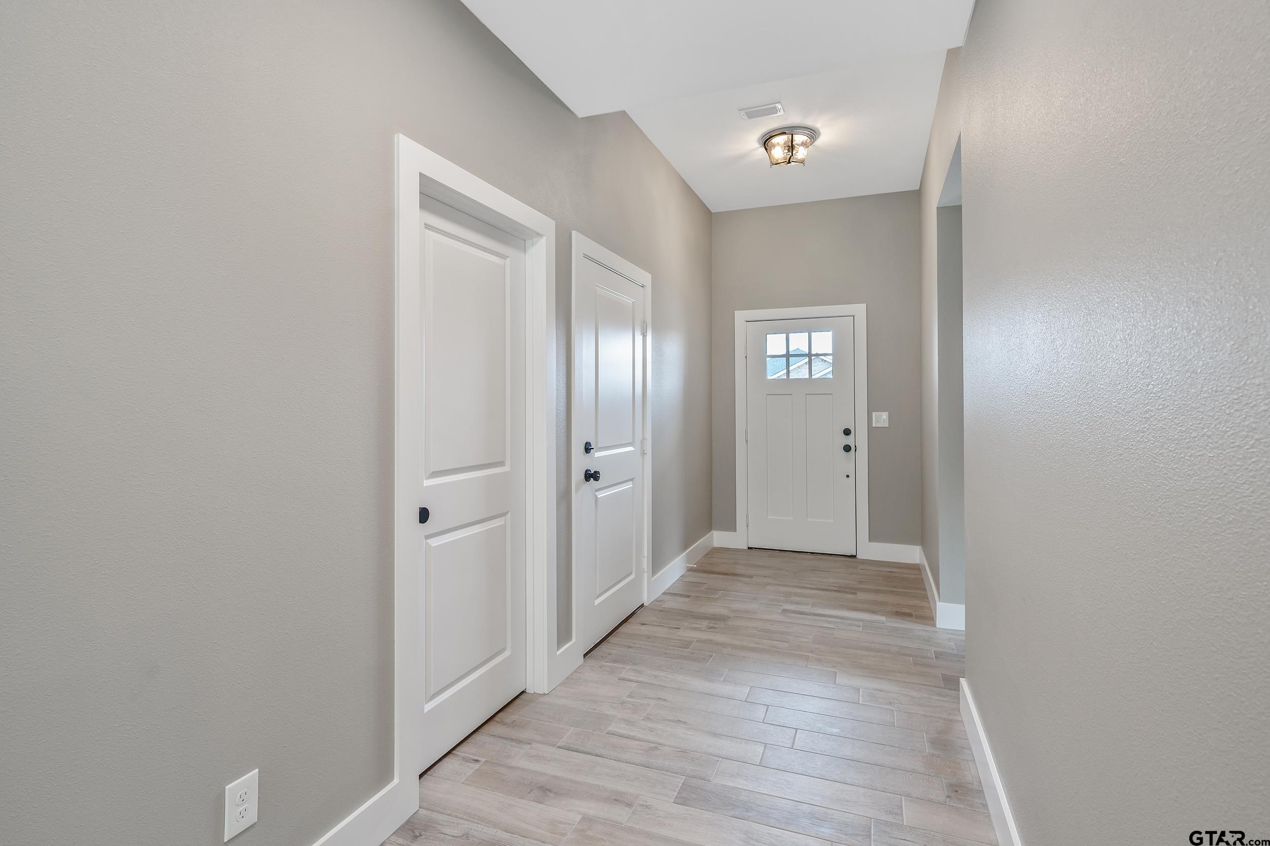 16218 Crossing Circle Lindale, TX 75771 - Photo 12 of 24 a view of a hallway with wooden floor