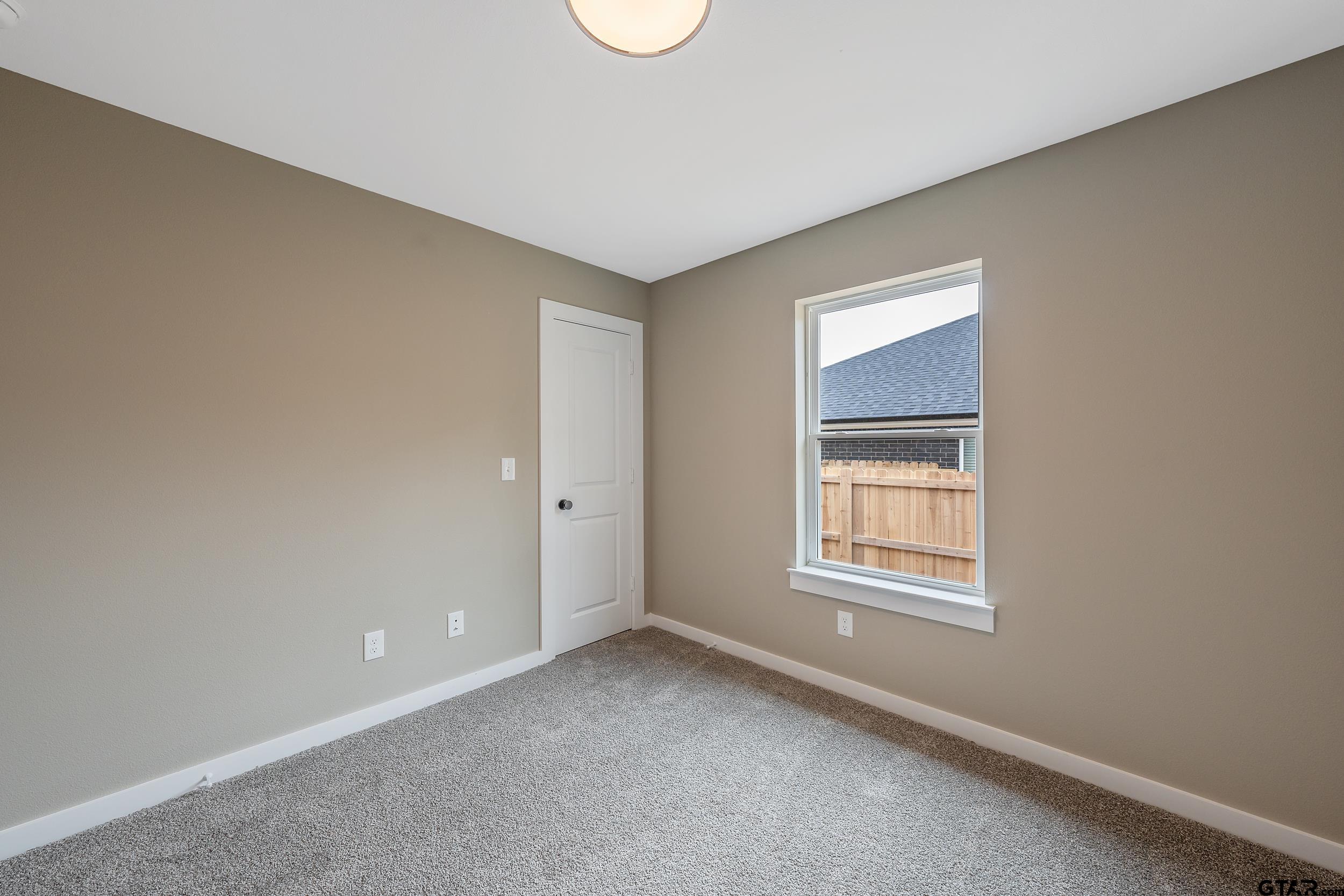 16218 Crossing Circle Lindale, TX 75771 - Photo 16 of 24 an empty room with windows and closet