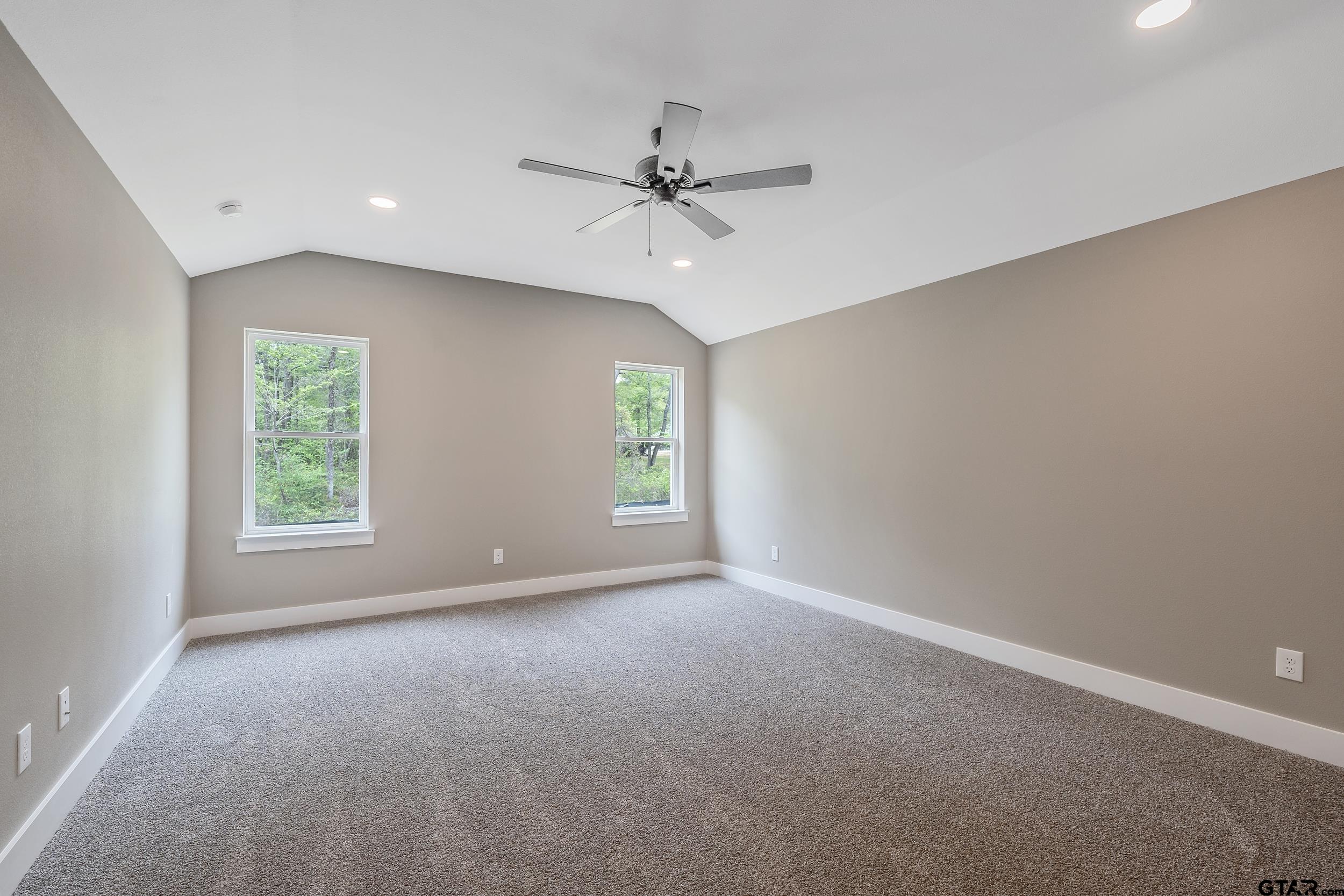 16218 Crossing Circle Lindale, TX 75771 - Photo 18 of 24 an empty room with windows and fan