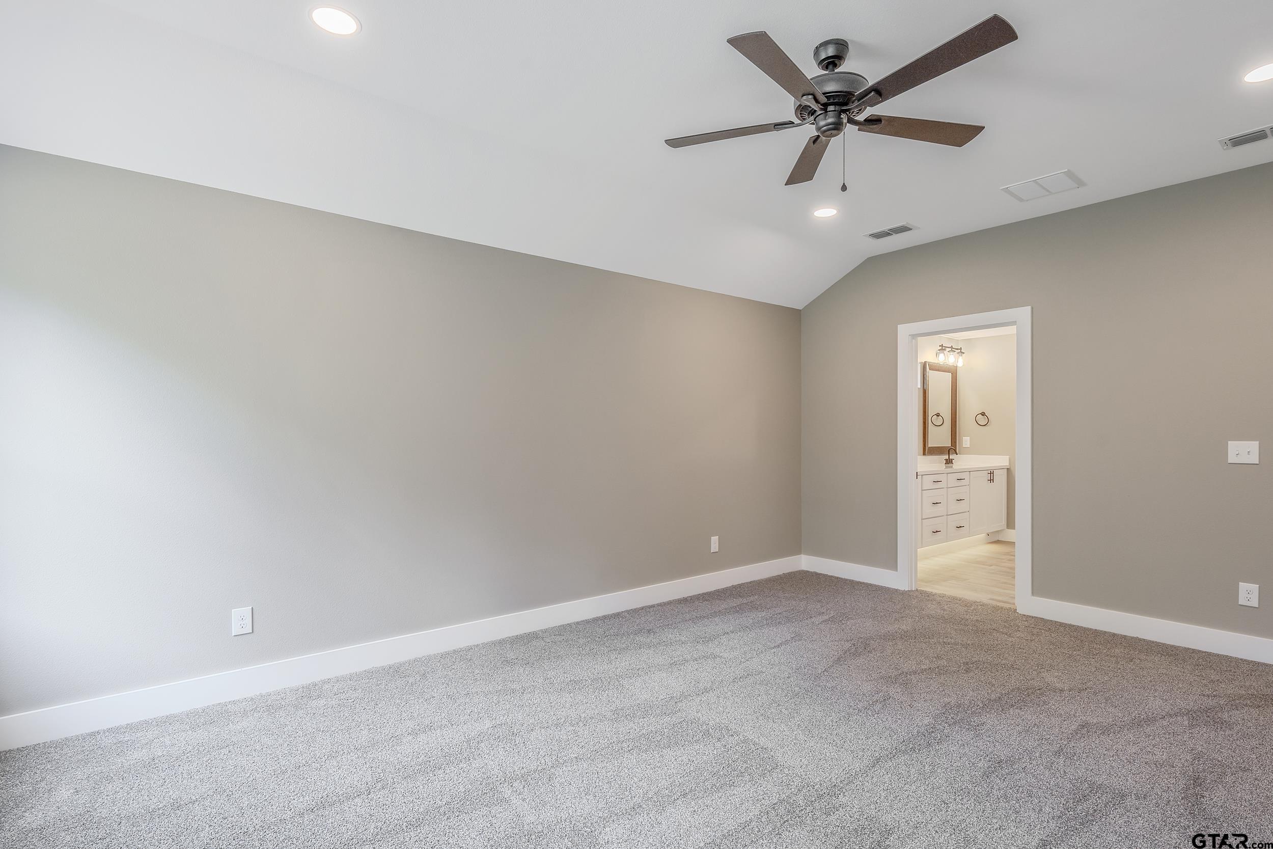 16218 Crossing Circle Lindale, TX 75771 - Photo 19 of 24 an empty room with a ceiling fan and a window