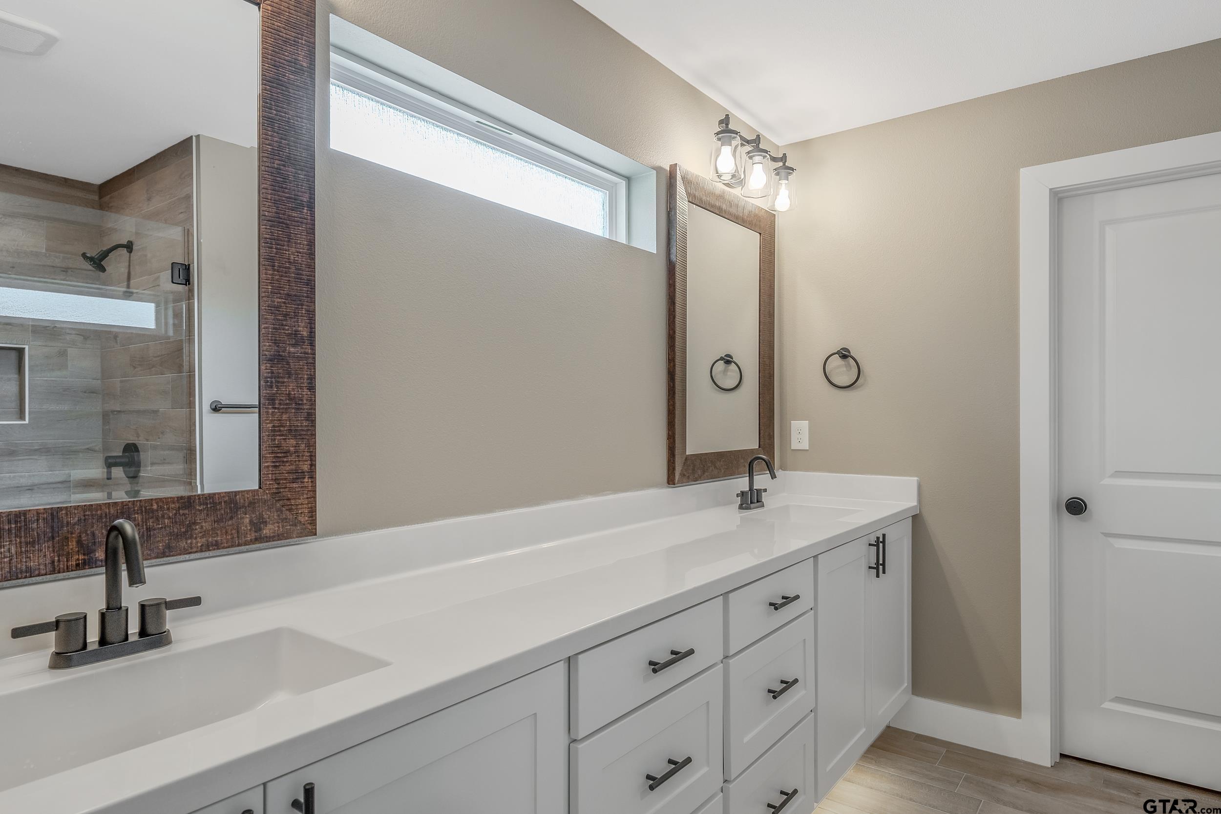 16218 Crossing Circle Lindale, TX 75771 - Photo 20 of 24 a bathroom with a sink and a mirror