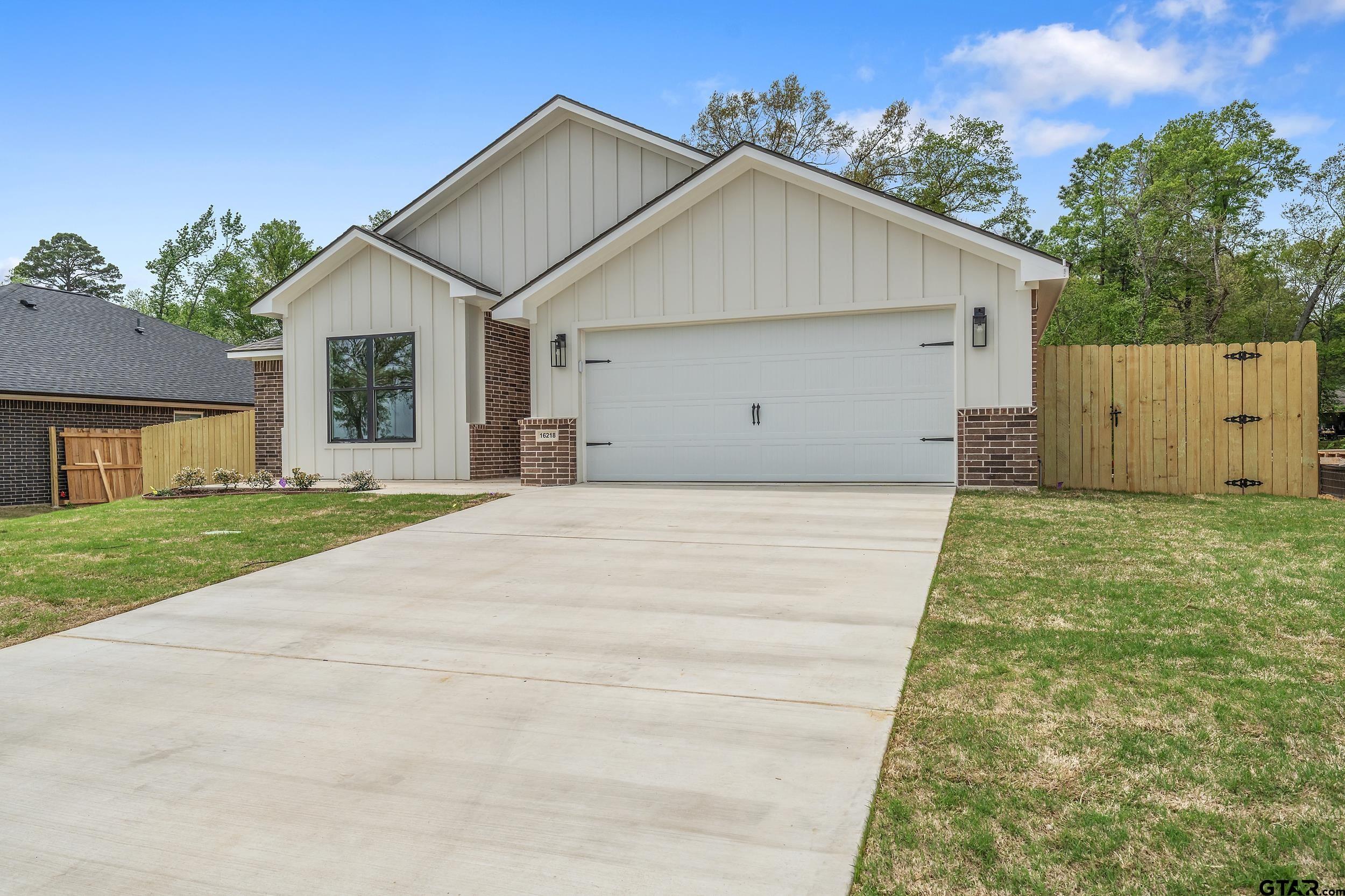 16218 Crossing Circle Lindale, TX 75771 - Photo 2 of 24 a view of a house with a yard and garage