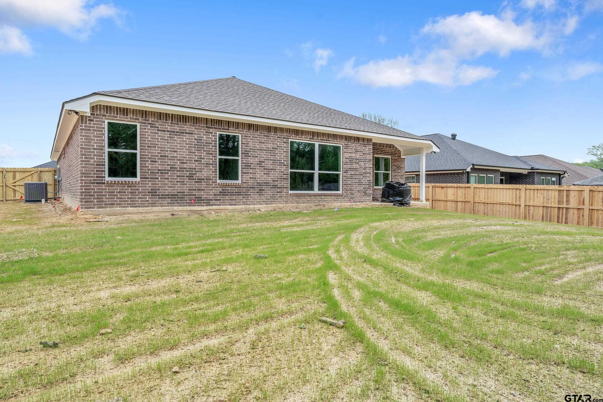16218 Crossing Circle Lindale, TX 75771 - Photo 23 of 24 a front view of a house with a yard