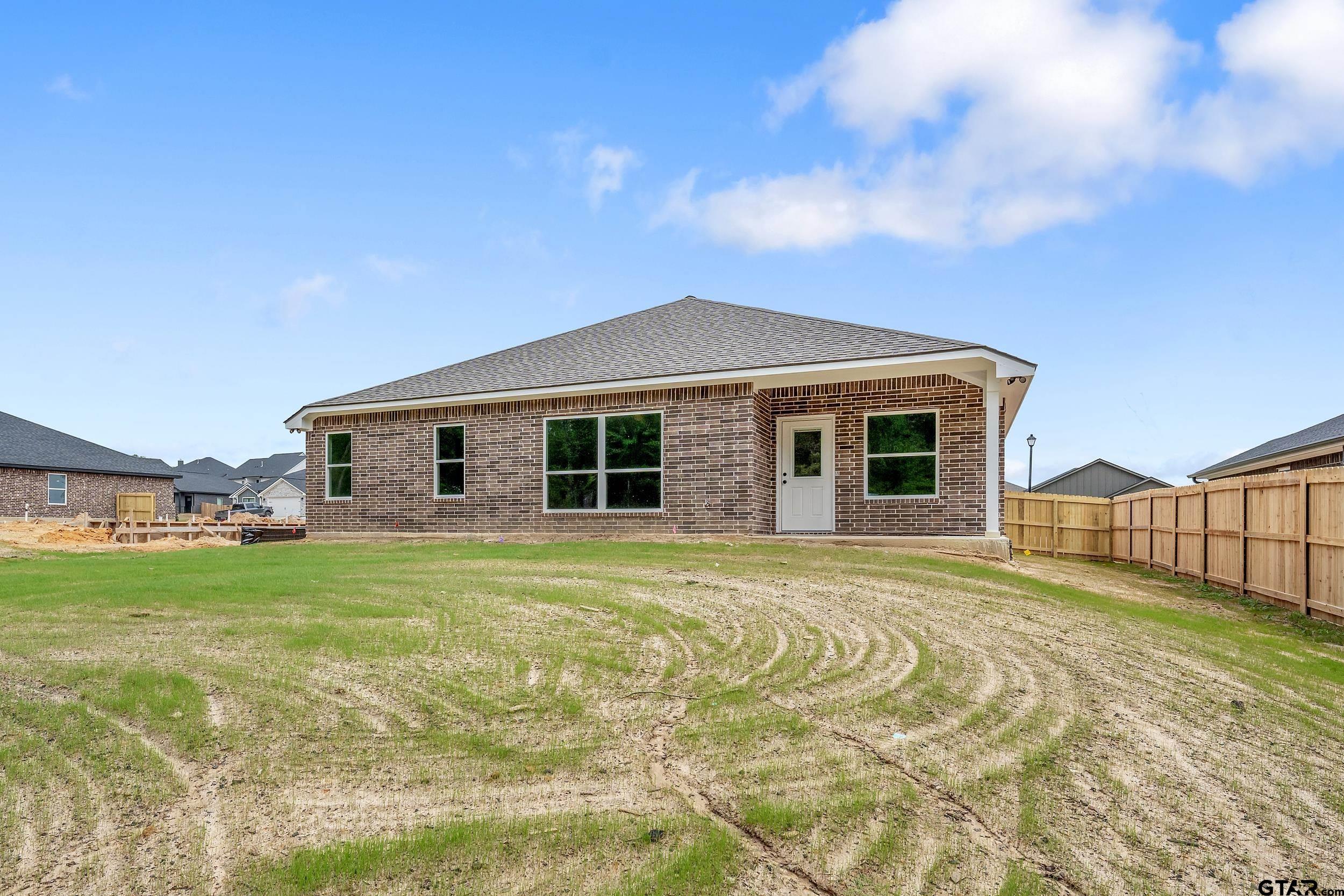 16218 Crossing Circle Lindale, TX 75771 - Photo 24 of 24 a front view of a house with a garden