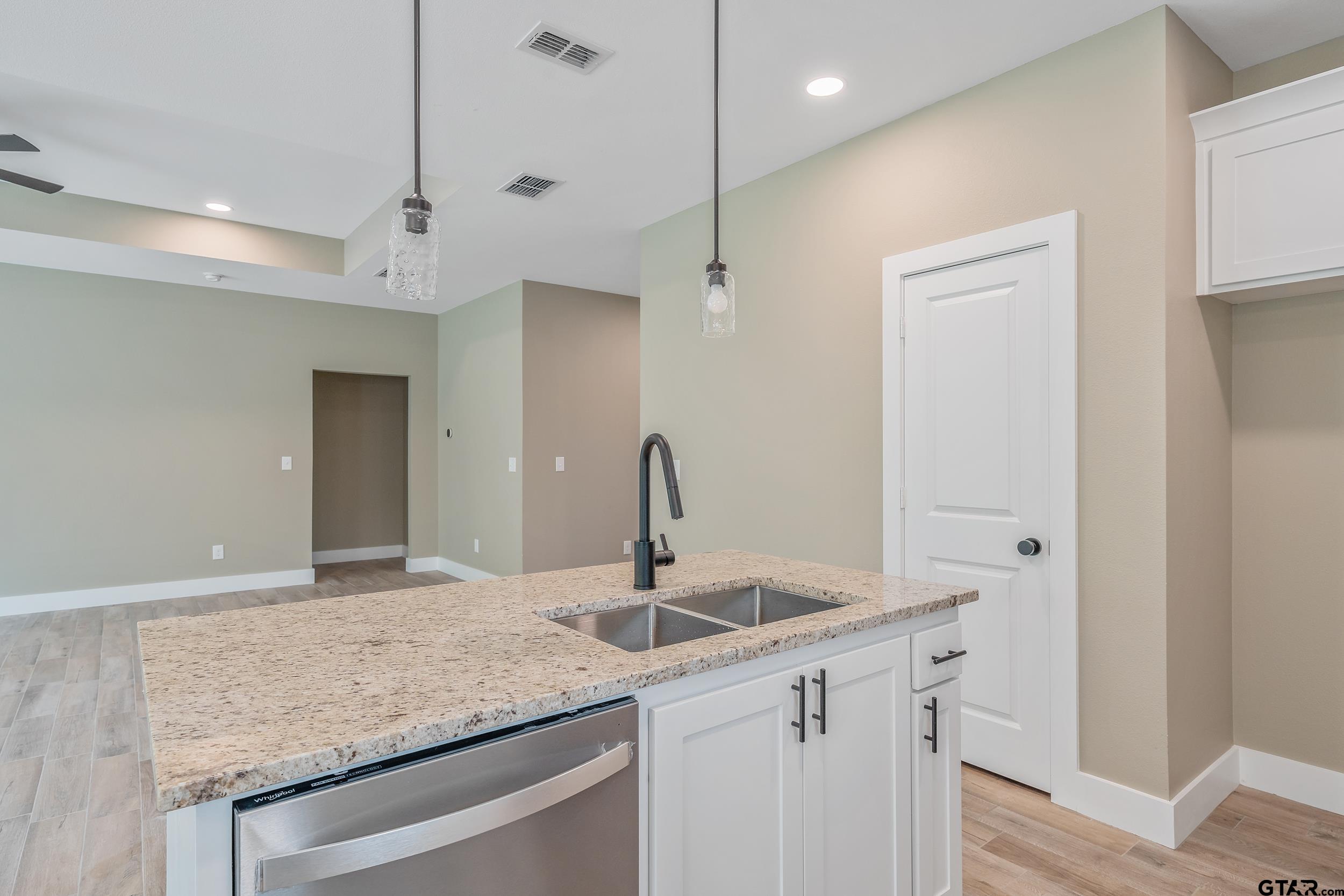 16218 Crossing Circle Lindale, TX 75771 - Photo 6 of 24 a kitchen with a sink a counter space and cabinets