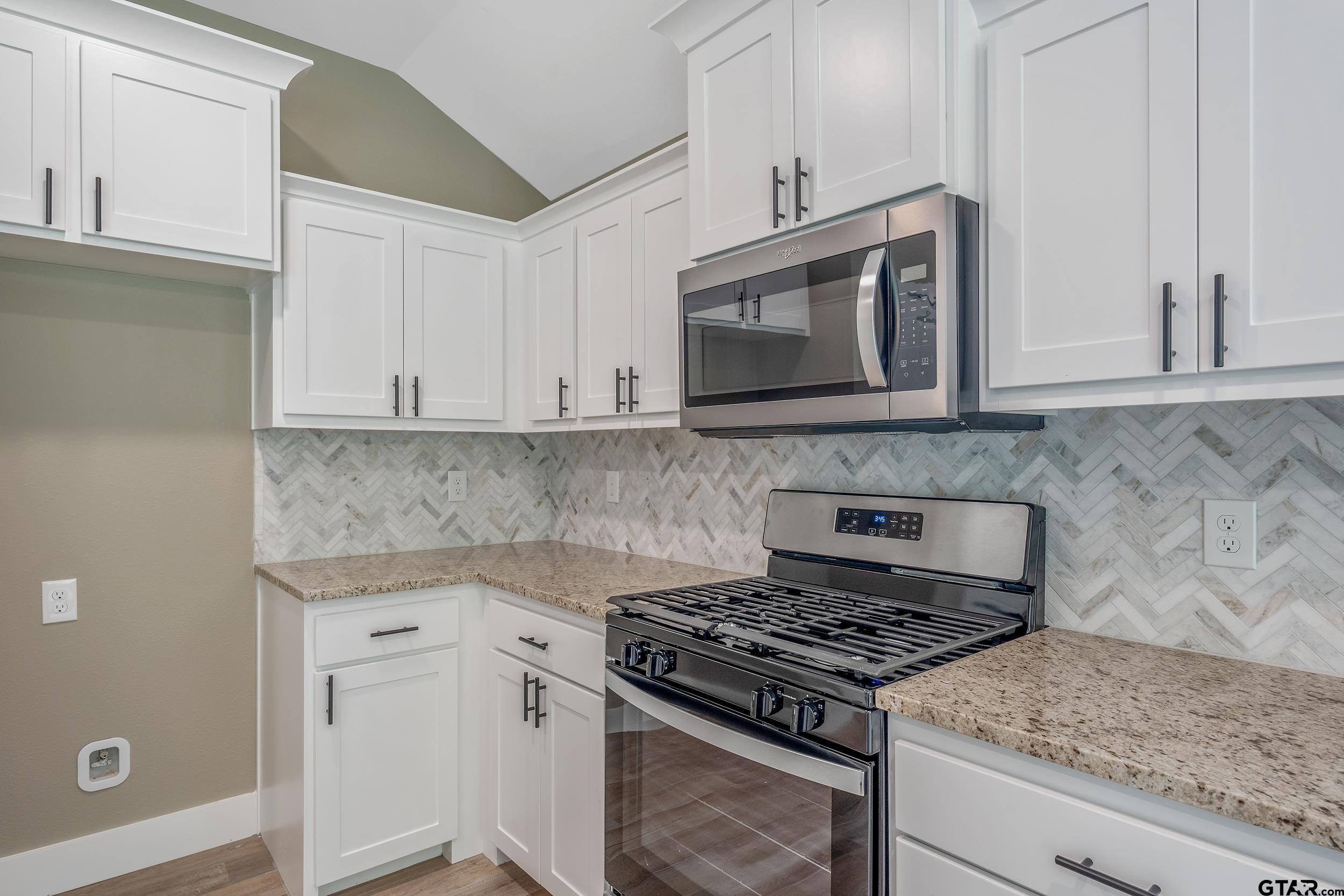 16218 Crossing Circle Lindale, TX 75771 - Photo 7 of 24 a kitchen with granite countertop cabinets stainless steel appliances and a counter space