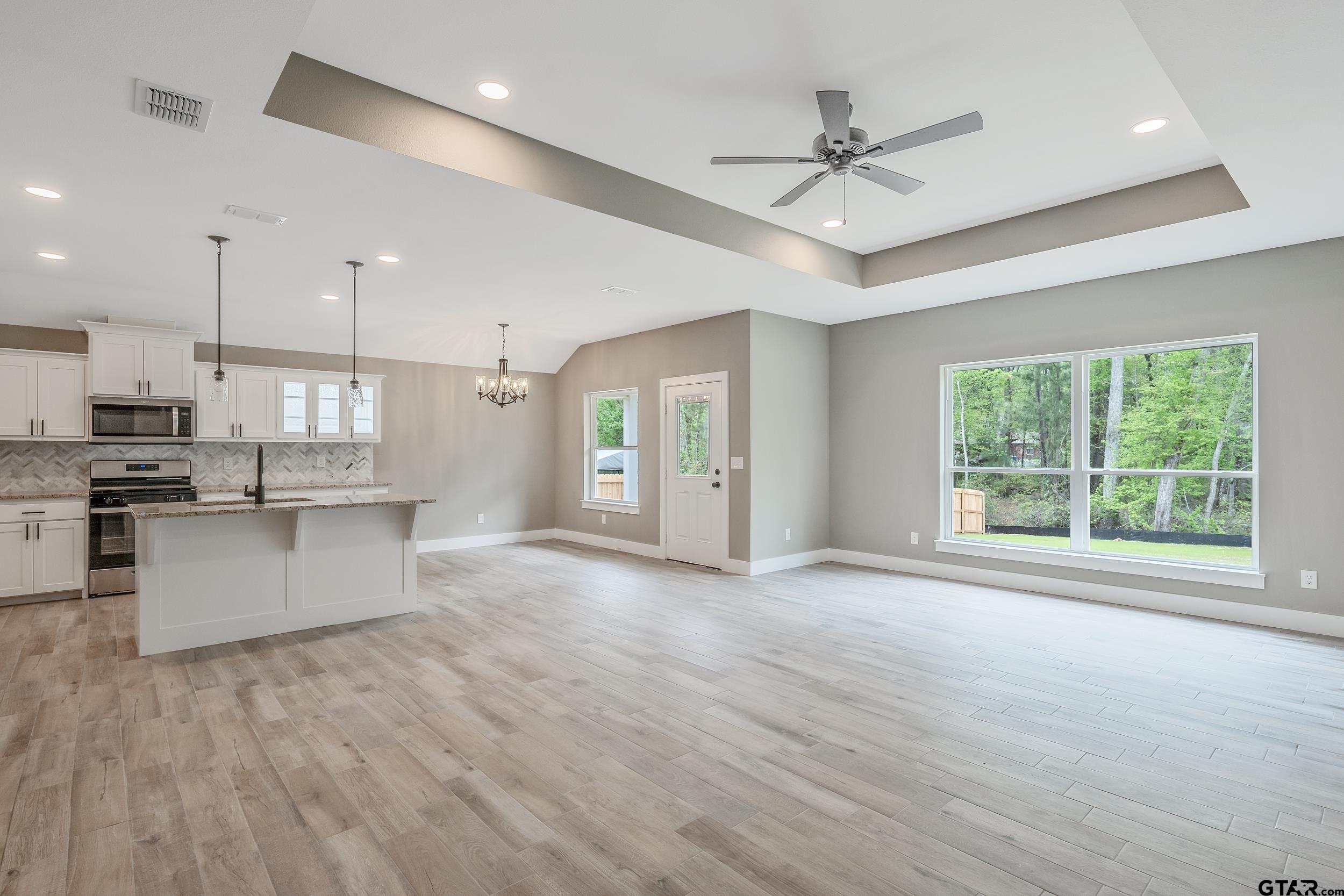 16218 Crossing Circle Lindale, TX 75771 - Photo 9 of 24 a view of an empty room with a window and kitchen view