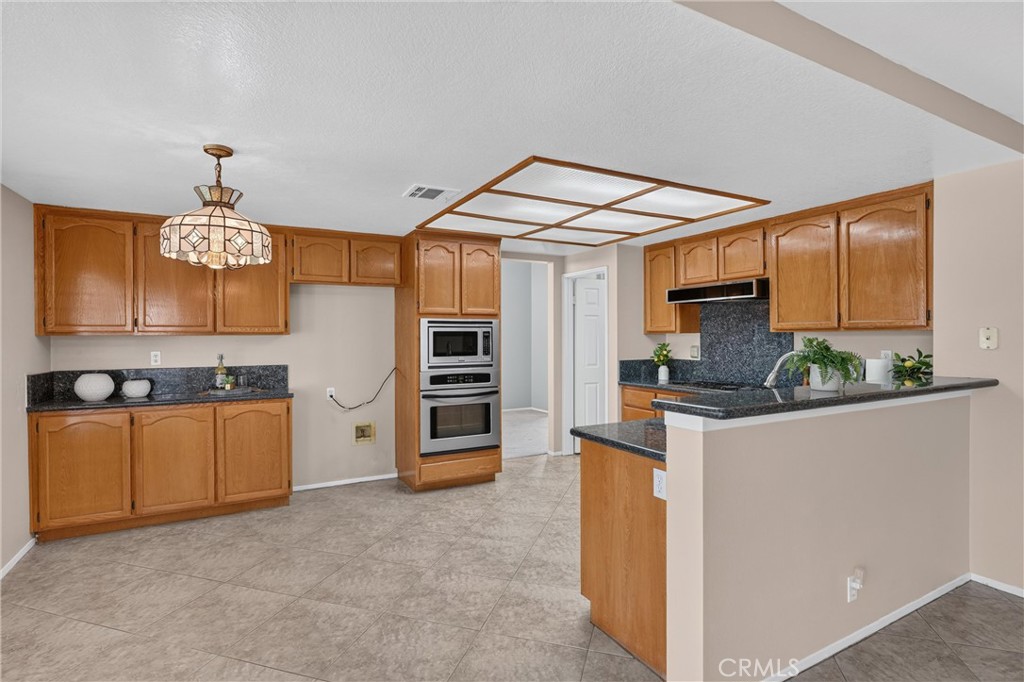 2000 Citrus Wood Lane Riverside, CA 92503 - Photo 12 of 51 Spacious Kitchen: Granite Countertops, Double Oven, Gas Cooktop, Microwave and Dishwasher. Plenty of Cabinets