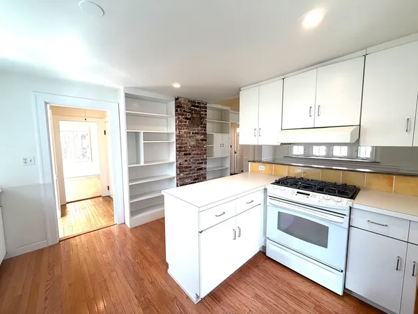 a kitchen with a stove top oven and cabinets