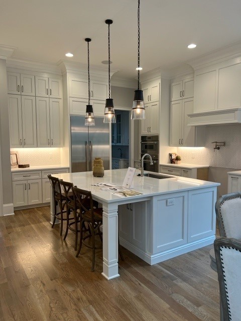191 Splendor Ridge Drive Franklin, TN 37064 - Photo 22 of 70 a kitchen with stainless steel appliances granite countertop a kitchen island a stove a sink a dining table and chairs
