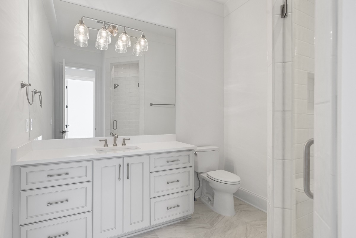 191 Splendor Ridge Drive Franklin, TN 37064 - Photo 50 of 70 a bathroom with a granite countertop sink a toilet and a mirror