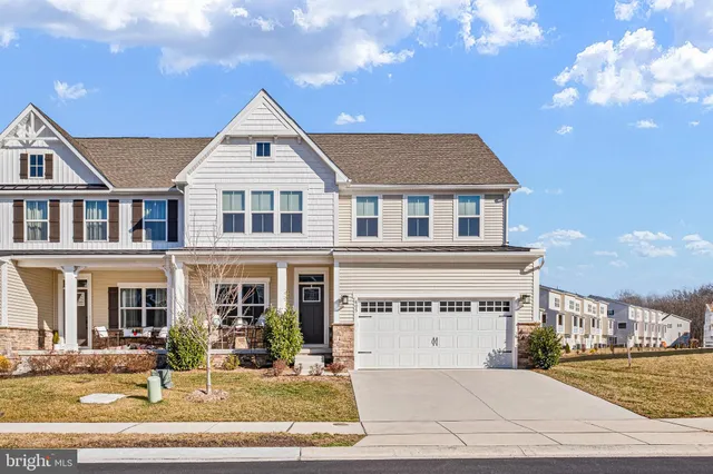 a front view of a house with yard and seating space