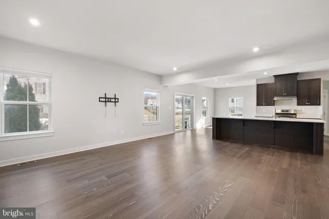 a large white kitchen with a large window