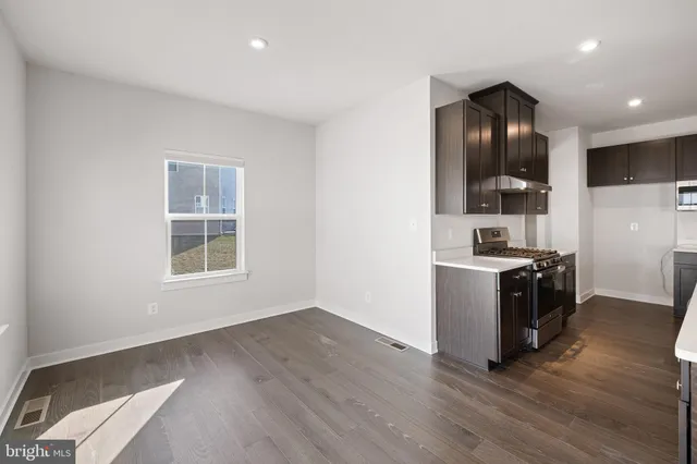 a view of kitchen with sink and wooden floor
