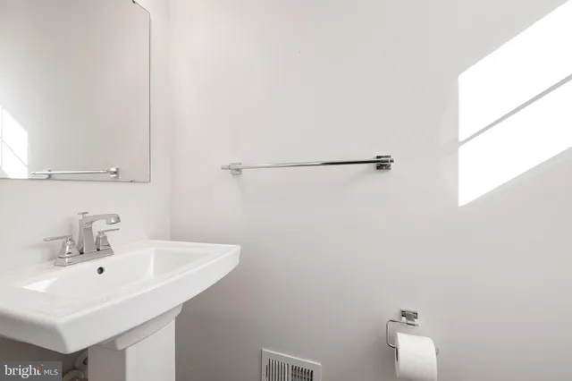 a bathroom with a sink and mirror