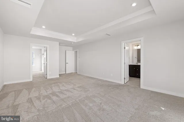 a view of an empty room with wooden floor and entryway