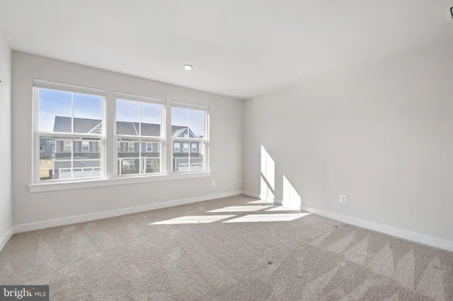 a view of a livingroom with wooden floor and a window