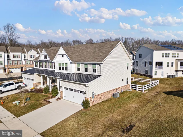 a view of a house with a wooden fence
