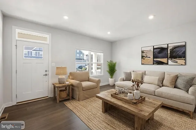 a living room with furniture ceiling fan and a rug